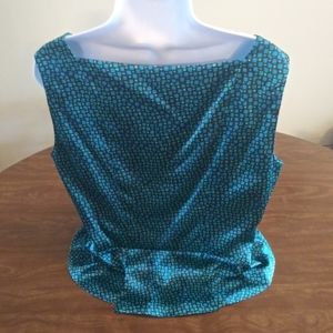 Neiman Marcus sleeveless top. Flair below waist